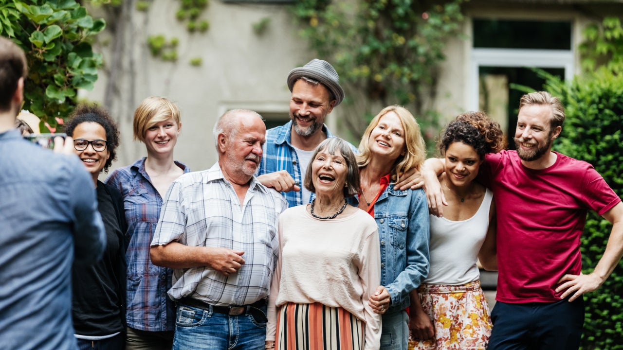 A group of family and friends stands together for a photo