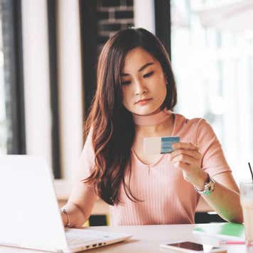 East Asian millennial woman investing in finances and technologies