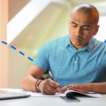 Person writing on a piece of paper