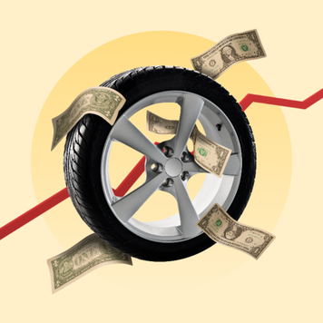 A car tire surrounded by American dollar bills. Behind the tire, there is a red line graph going up and to the right.