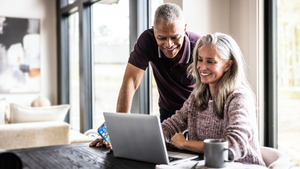 Older couple using a laptop at home.